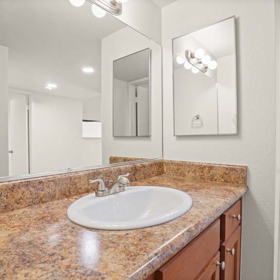 a bathroom with a sink and mirror.