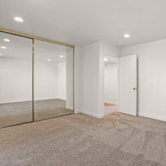 a room with a carpeted floor and a glass door.