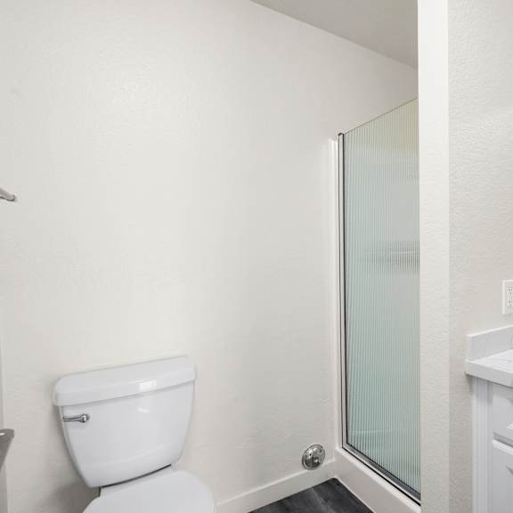 a white toilet sits next to a sink in a bathroom.