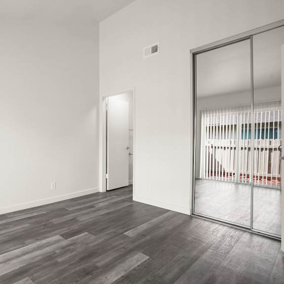 a room with a grey floor and a white wall.