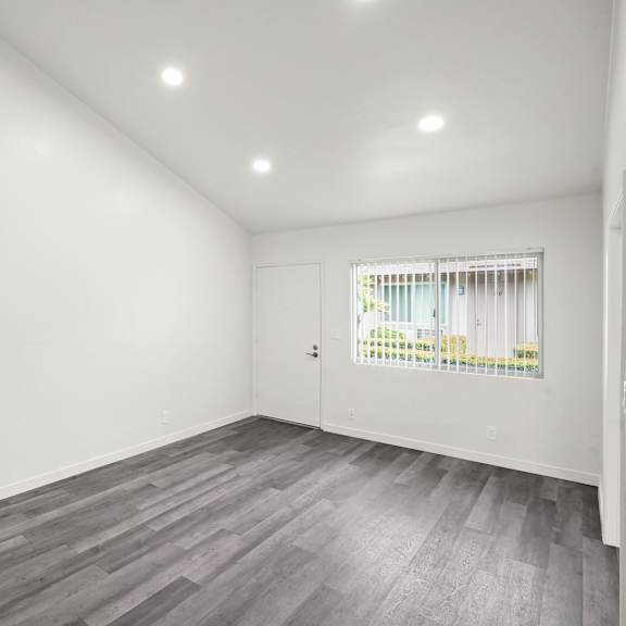 a room with a grey floor and white walls.