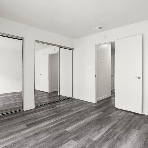 a room with a wooden floor and white walls.