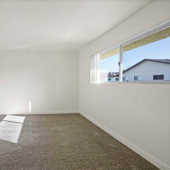 a room with white walls and a carpeted floor.