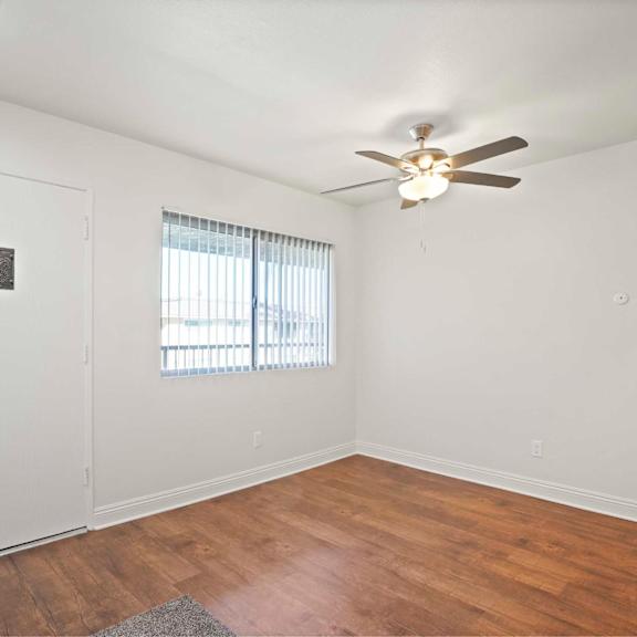 a room with a ceiling fan and a door.