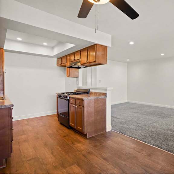 a room with a wooden floor and a ceiling fan.
