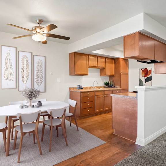 a dining room with a white table and chairs.