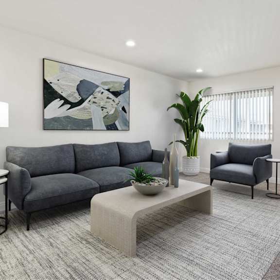 a grey sofa with a grey cushion and a grey chair with a black base.