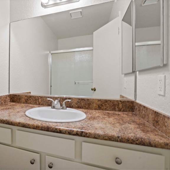 a bathroom with a sink and a mirror.
