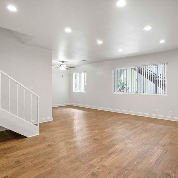 a room with wooden floors and white walls.