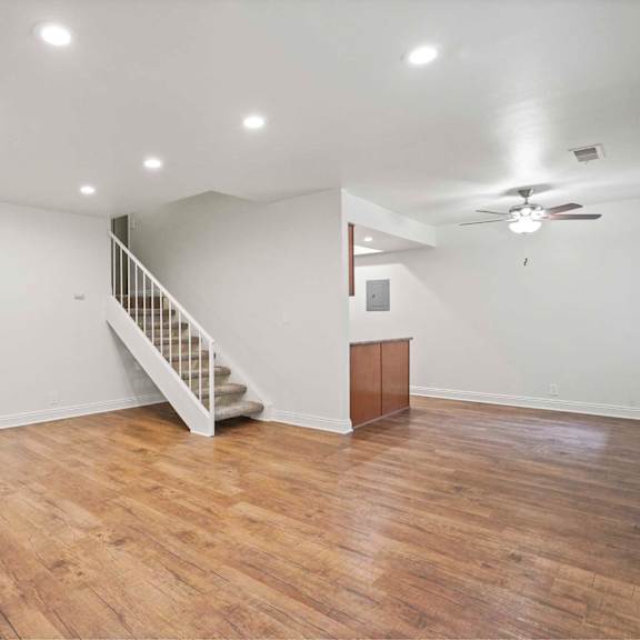 a room with wooden floors and a staircase.