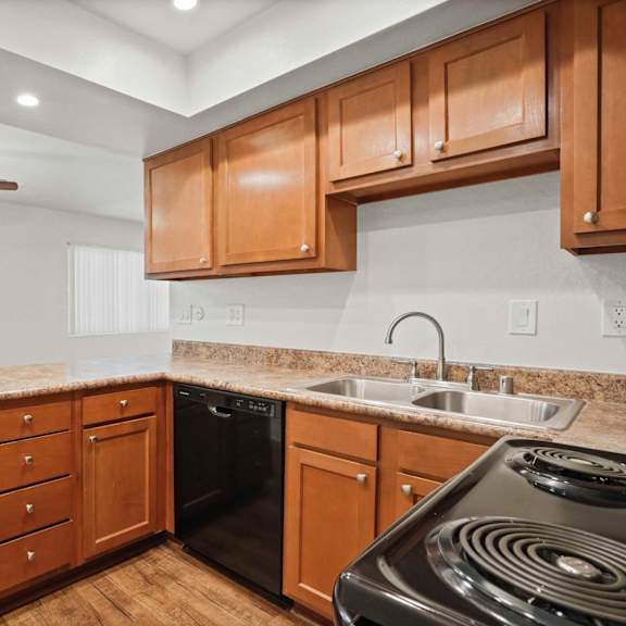 a kitchen with wooden cabinets and a black stove top.