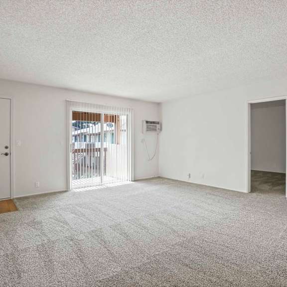 a room with a carpeted floor and white walls.