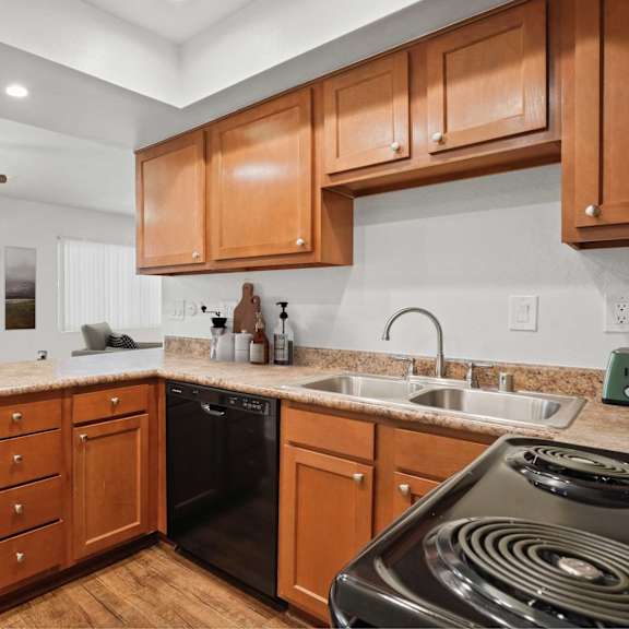 a kitchen with wooden cabinets and a black stove top.