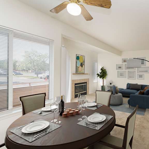 a dining room with a table set for two and a kitchen area in the background.