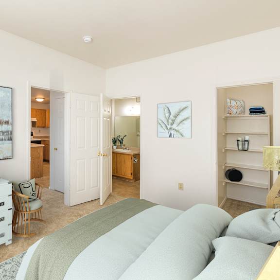 a bedroom with a large bed and a white dresser.