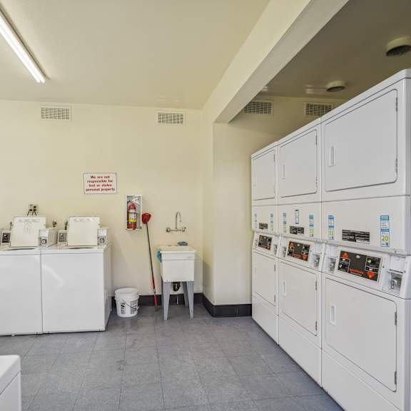 a laundry room with washers and dryers.