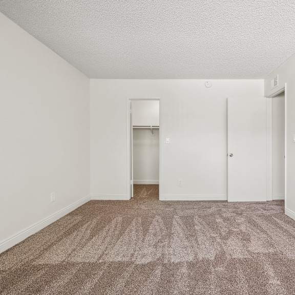 a room with a carpeted floor and white walls.