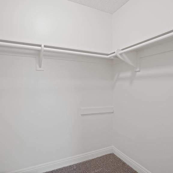 a white wall with a grey carpet.