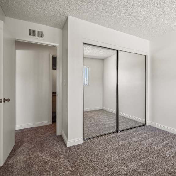 a room with a carpeted floor and a sliding glass door.