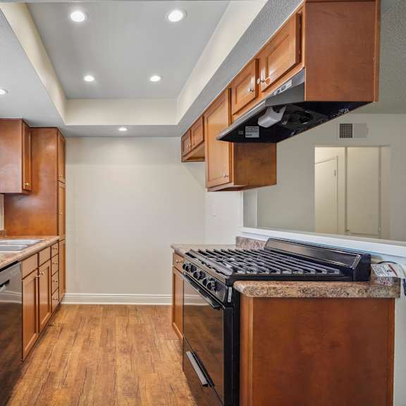 a kitchen with wooden cabinets and a granite countertop.
