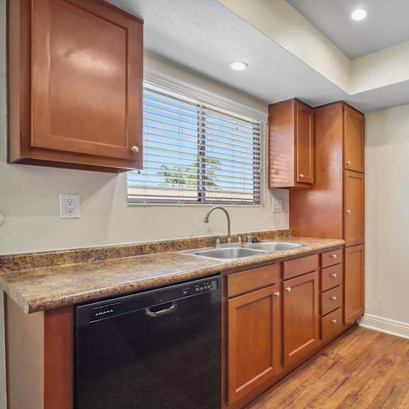 a kitchen with wooden cabinets and a black stove top.