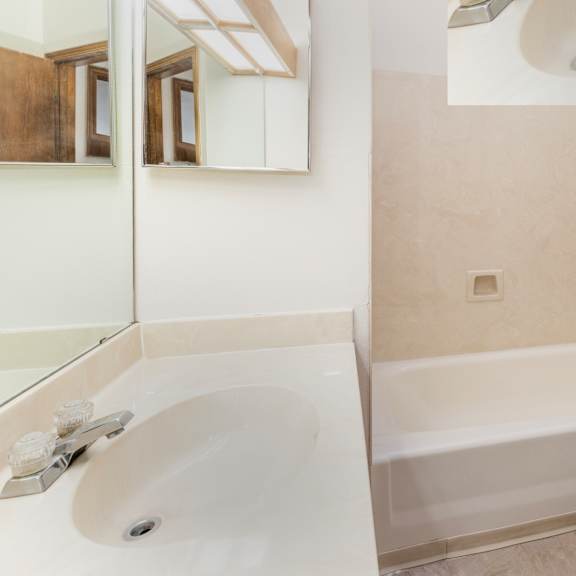 a white bathroom with a sink, toilet and bathtub.