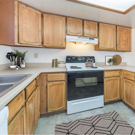 a kitchen with wooden cabinets and a white oven.