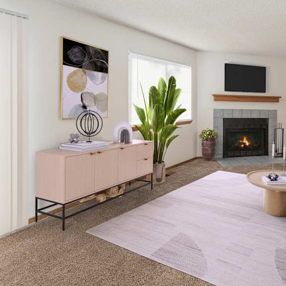 a living room with a fireplace, a grey couch, and a painting on the wall.