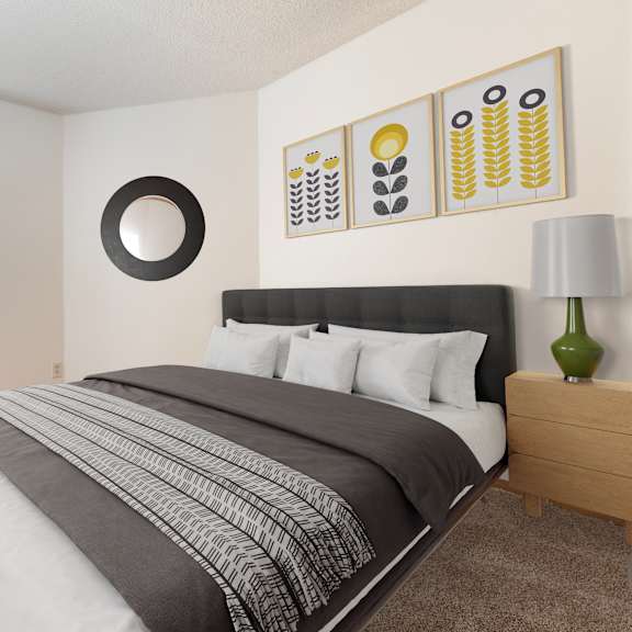 a bedroom with a large bed and a green plant.