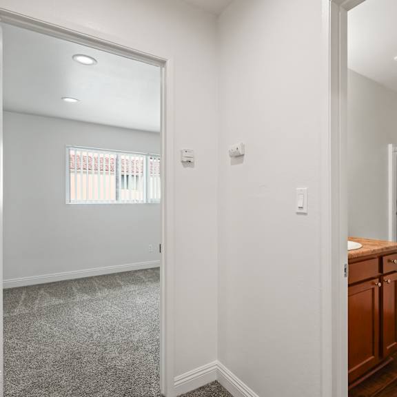 a bathroom with a toilet, sink, and a mirror.