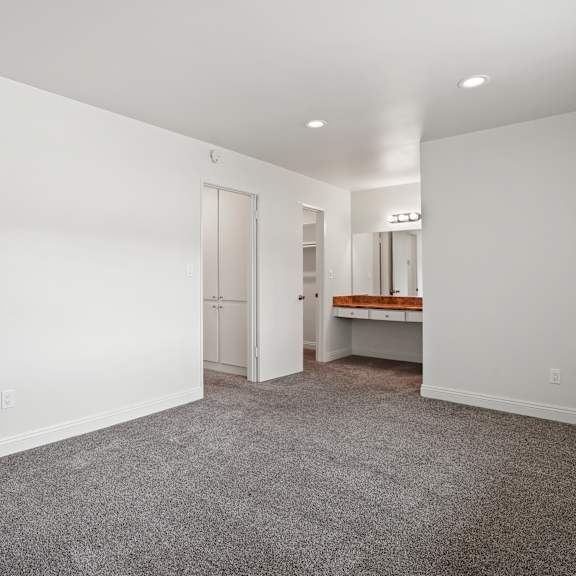 a large empty room with a carpeted floor and white walls.