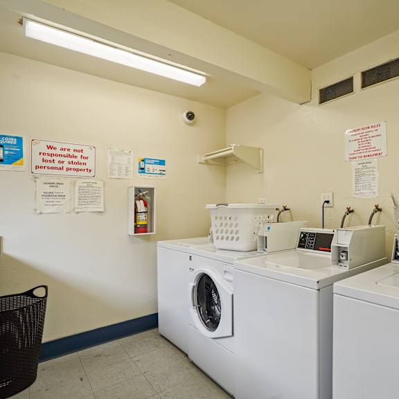 a laundromat with a sign that says "we are not responsible for personal property.".