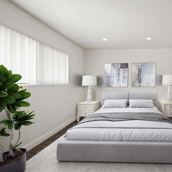 a bedroom with a large bed and two lamps.