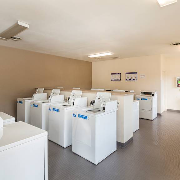 a laundromat with rows of washers and dryers.