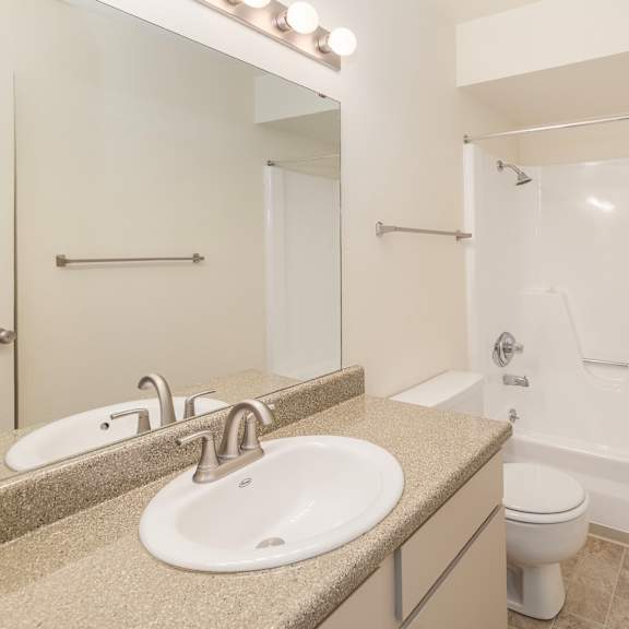 a bathroom with a sink, toilet, and bathtub.