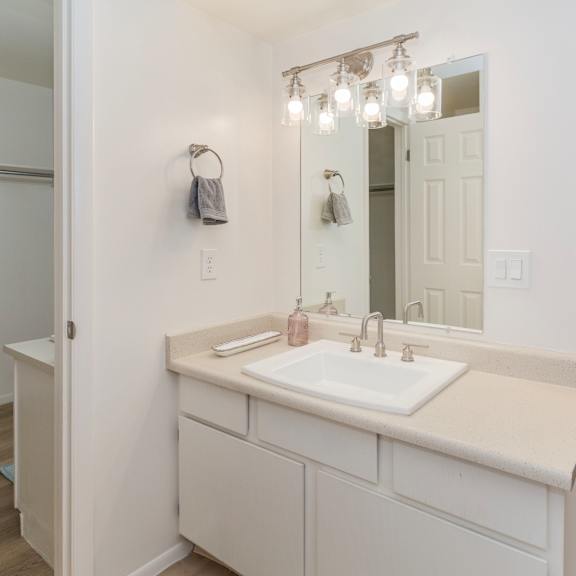 a bathroom with a white sink and a mirror.