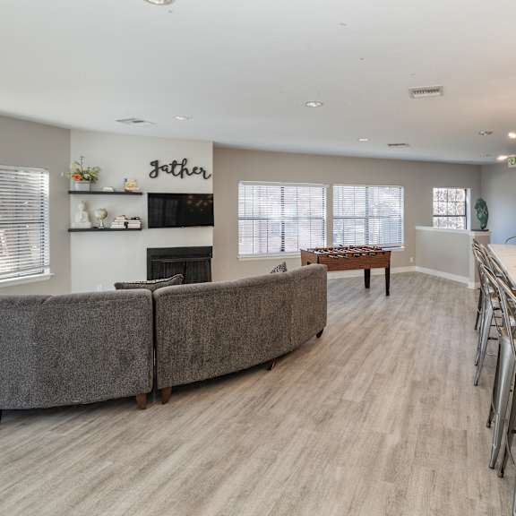 a modern dining room with a long table and chairs.