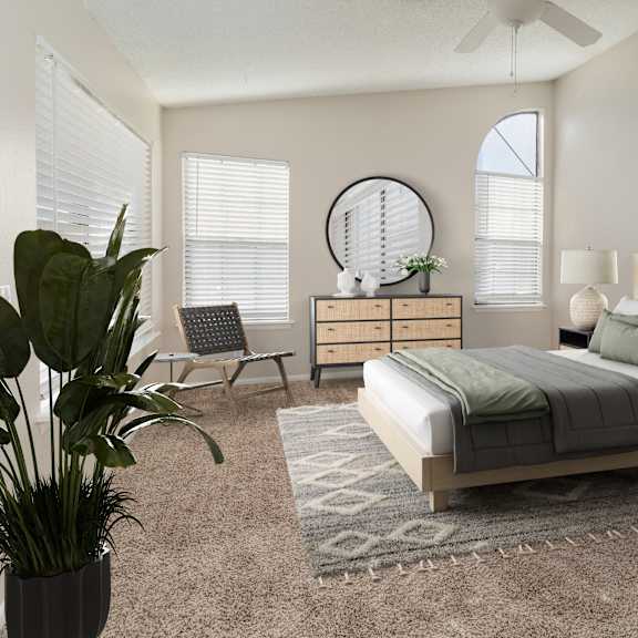 a bedroom with a large bed, a potted plant, and a mirror on the wall.