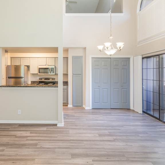 a kitchen with a refrigerator, microwave, and oven.