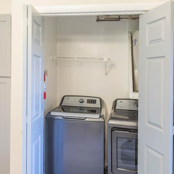 a small laundry room with a washer and dryer.