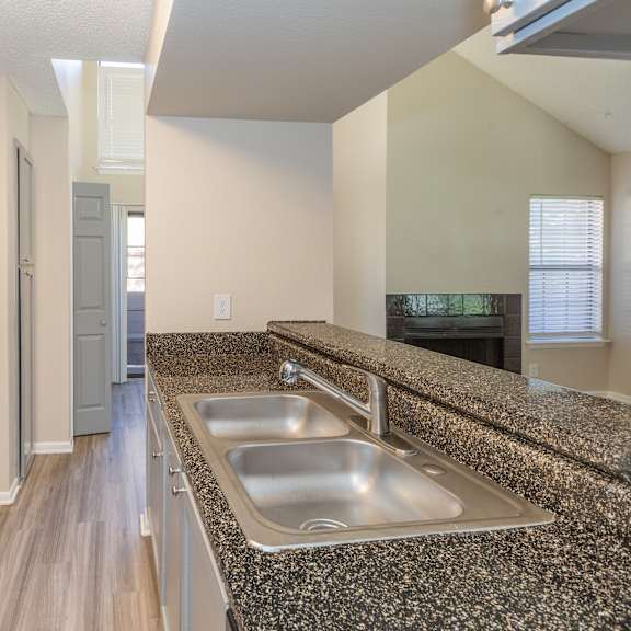 a kitchen with granite countertops and stainless steel appliances.