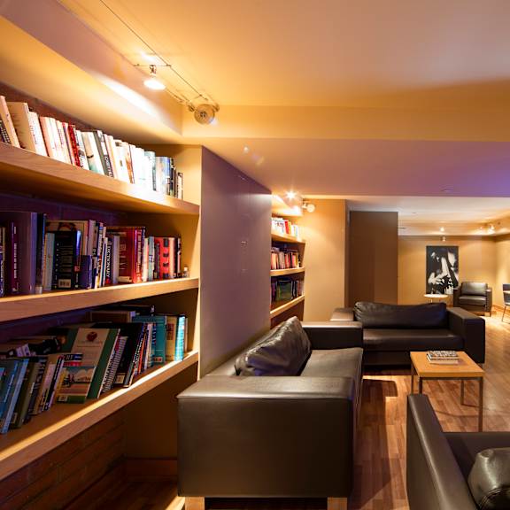 a living room with a fireplace and a bookshelf filled with books.