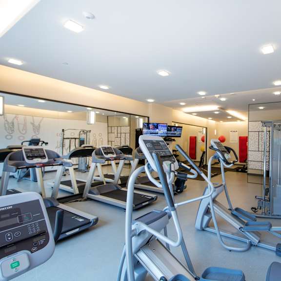 a gym with treadmills and exercise equipment.