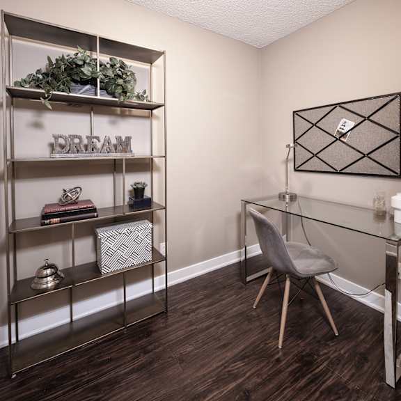 a room with a desk, chair, and shelving unit with the word "dream" on it.