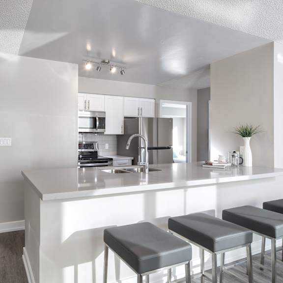 a kitchen with a bar area and stools.