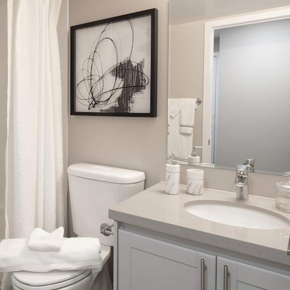 a white toilet with a white towel on top of it.