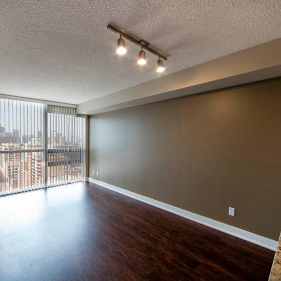 a room with a sliding glass door leading to a balcony.