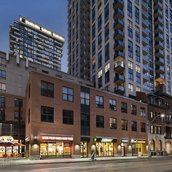 a city street with a building that has a sign that says "good food market".