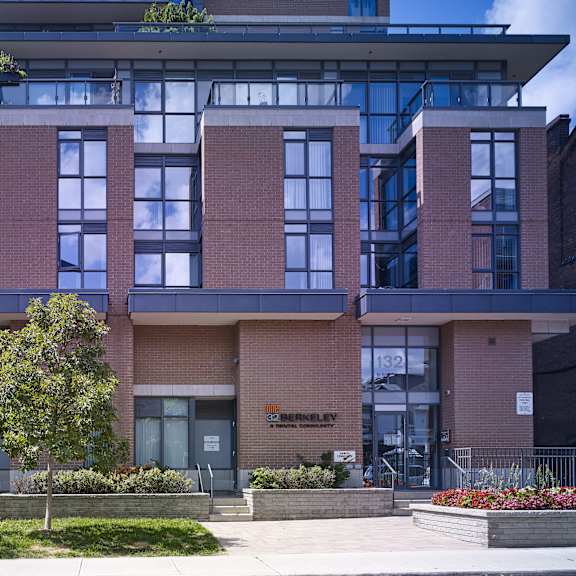 a modern building with a green tree in front.