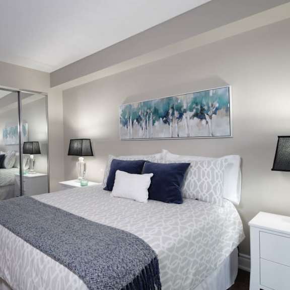 a bedroom with a bed and a mirror